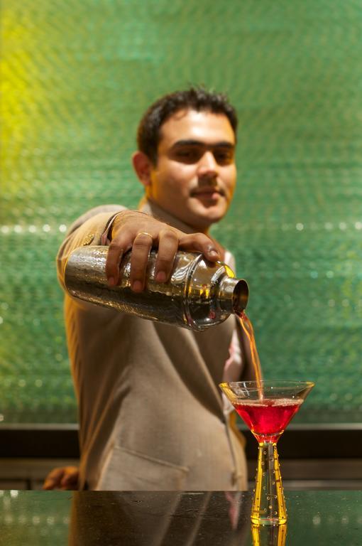 Vivanta Hyderabad, Begumpet Exteriör bild A bartender pouring a drink